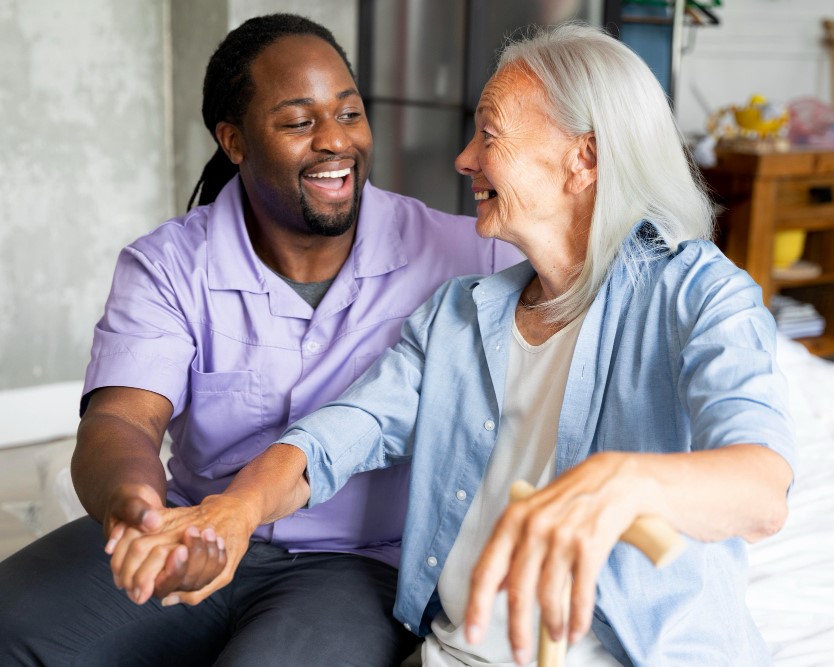 Caregiver assisting with light home maintenance and cleaning tasks for a senior
