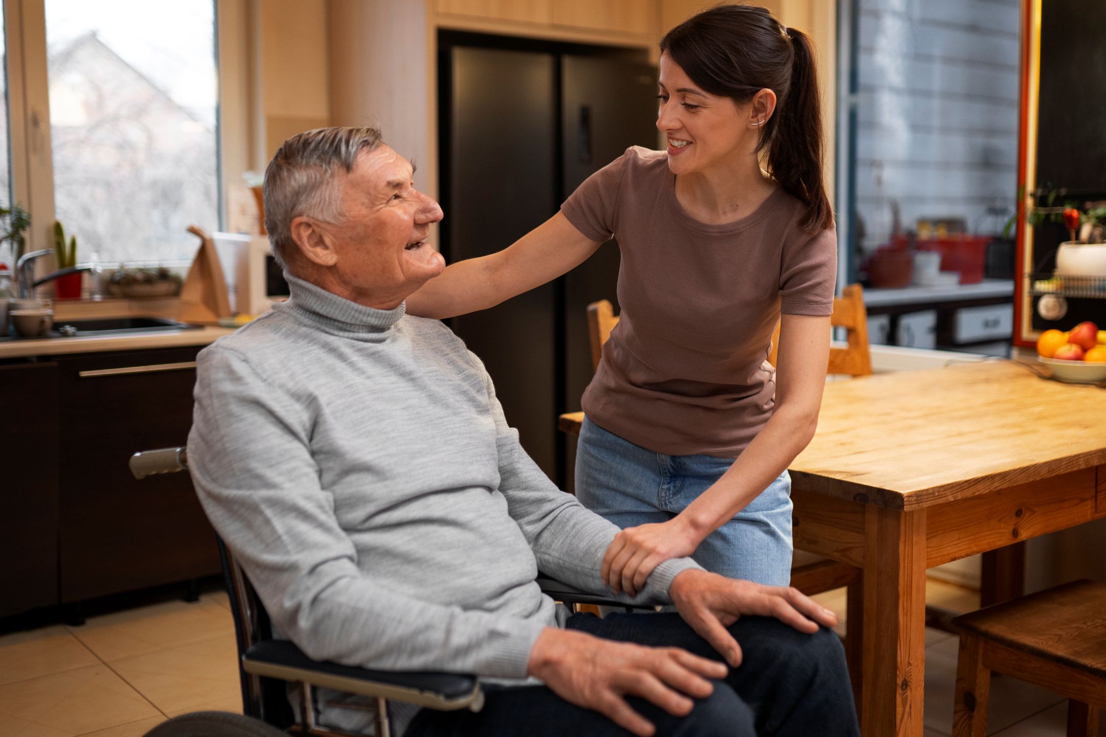 Caregiver consulting with an elderly client about Adult Family Living program options in Connecticut